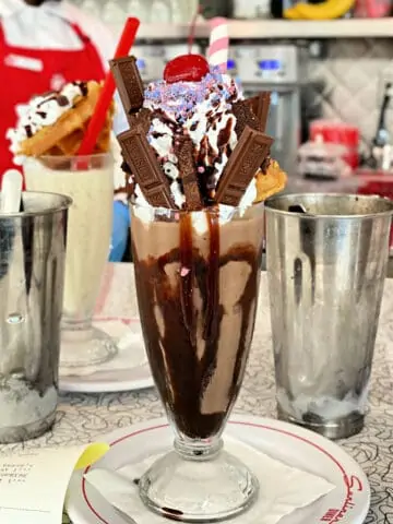 Chocolate Milkshake with mini Hershey bars, whipped cream, and a cherry on top.
