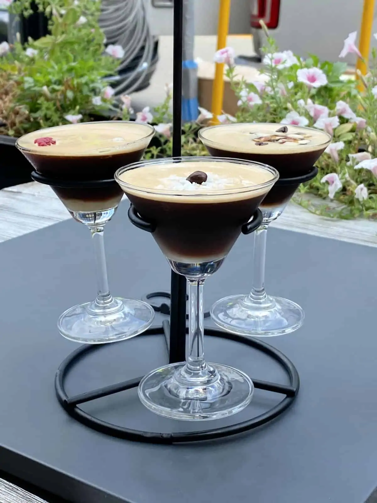 Three coffee martinis on a stand.